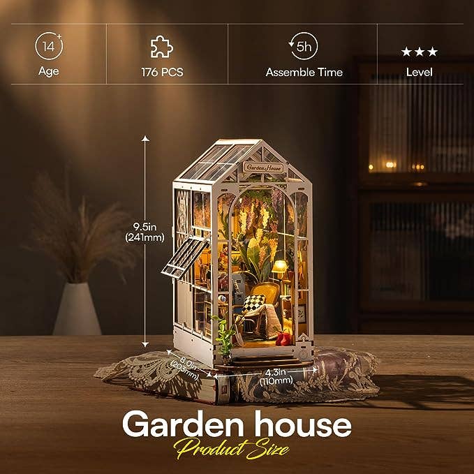Model of a garden house with assembly details on a wooden surface