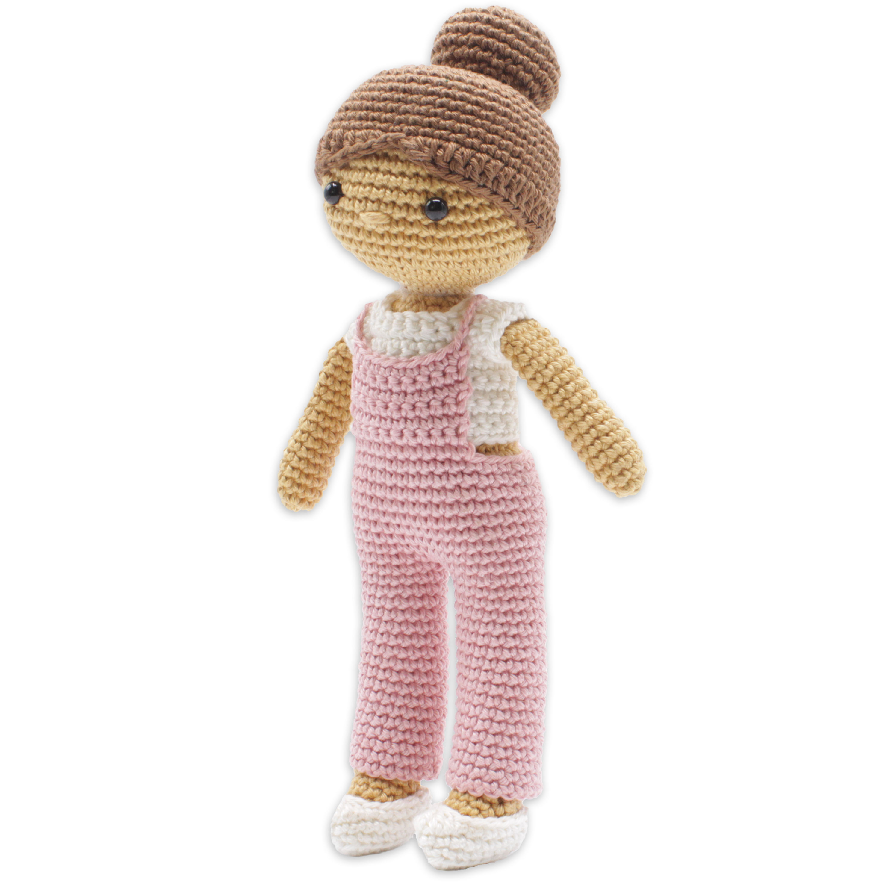 Crocheted doll with pink overalls and brown hair on a white background
