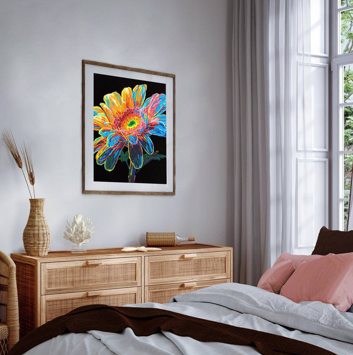 Colorful flower artwork on a wall above a wooden dresser in a bedroom.