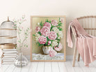 Framed artwork of pink and white flowers on a wall with decorative elements.
