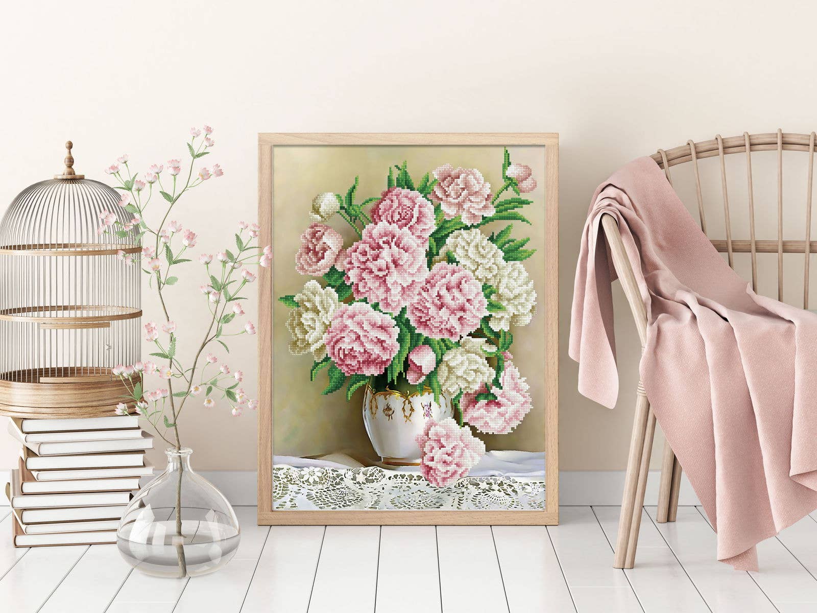 Framed artwork of pink and white flowers on a wall with decorative elements.