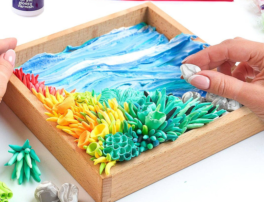 Colorful sensory kit with hands interacting with the materials on a white background