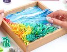 Colorful sensory kit with hands interacting with the materials on a white background