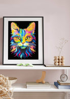 Framed colorful cat painting on a wall above a shelf with decorative items.