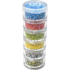 Stack of clear containers with colorful beads on a white background