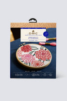 DMC embroidery kit packaging with floral design on a blue background