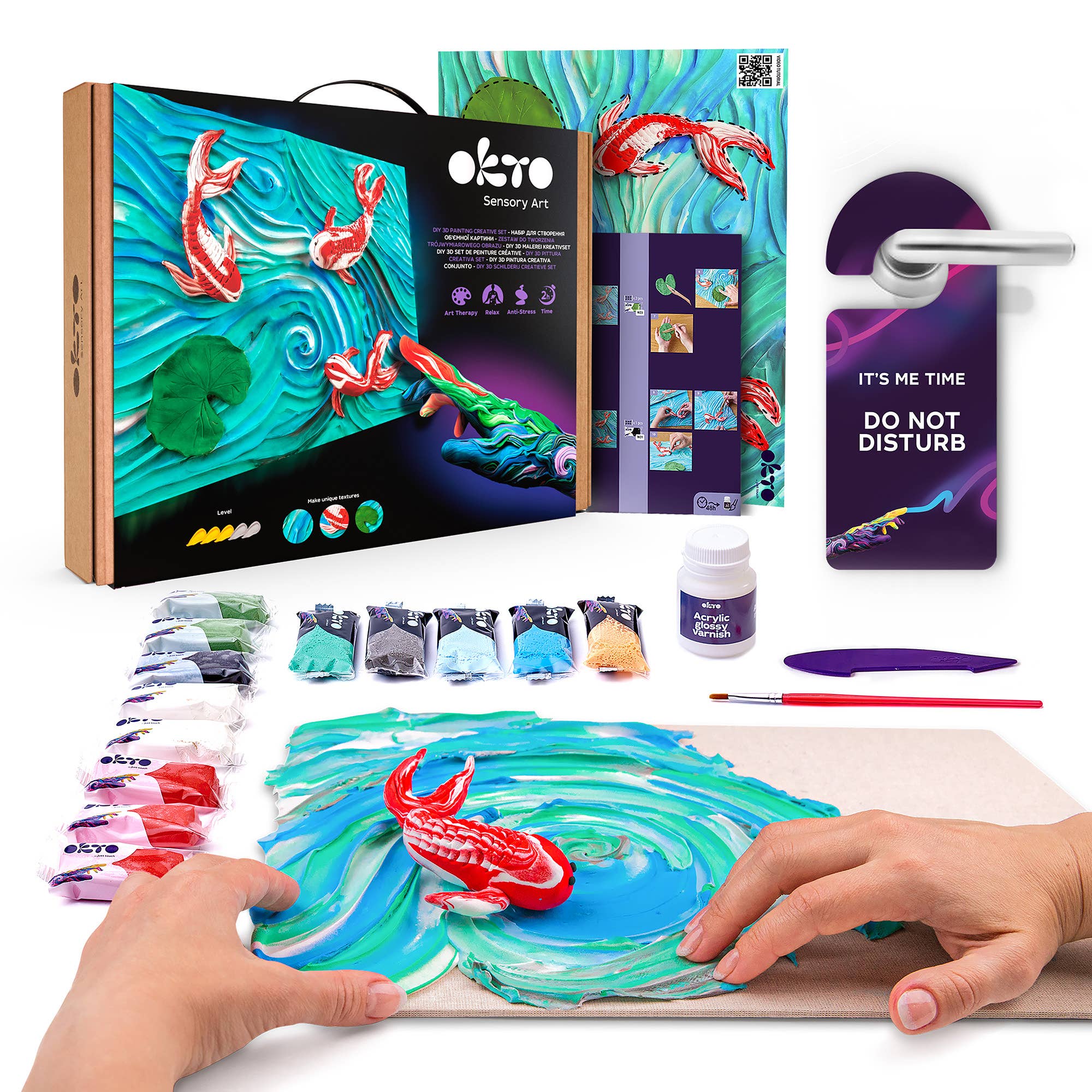 Artistic sensory art kit with koi fish design, paint bottles, and a brush on a white background.