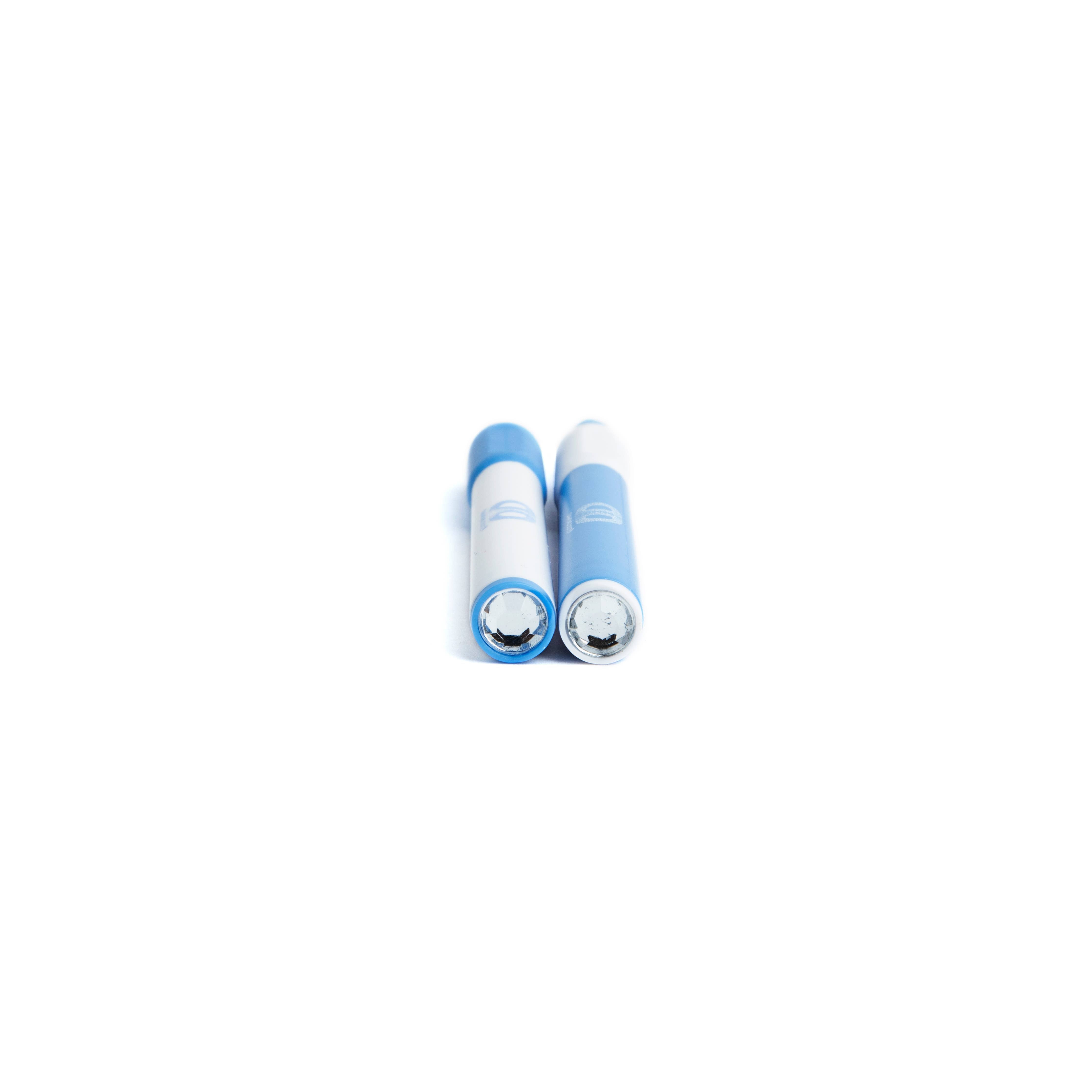 Two blue and white cylindrical batteries on a white background