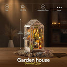 Model of a garden house with assembly details on a wooden surface