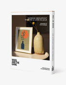 Wool and the Gang needlepoint kit packaging with a sample design and vase on a white background