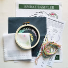 Embroidery kit with hoop, threads, and instructions on a white background