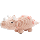 Crocheted dinosaur toy with pink body and white spikes on a white background