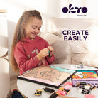 Child engaged in art activity with 'Okto Sensory Art' products on a table.