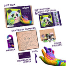 Gift box with Canvas by Numbers set, instruction manual, hanger, tool, and color palettes on a white background.