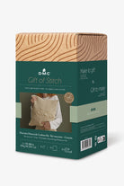 DMC gift of stitch packaging with a wooden texture on top