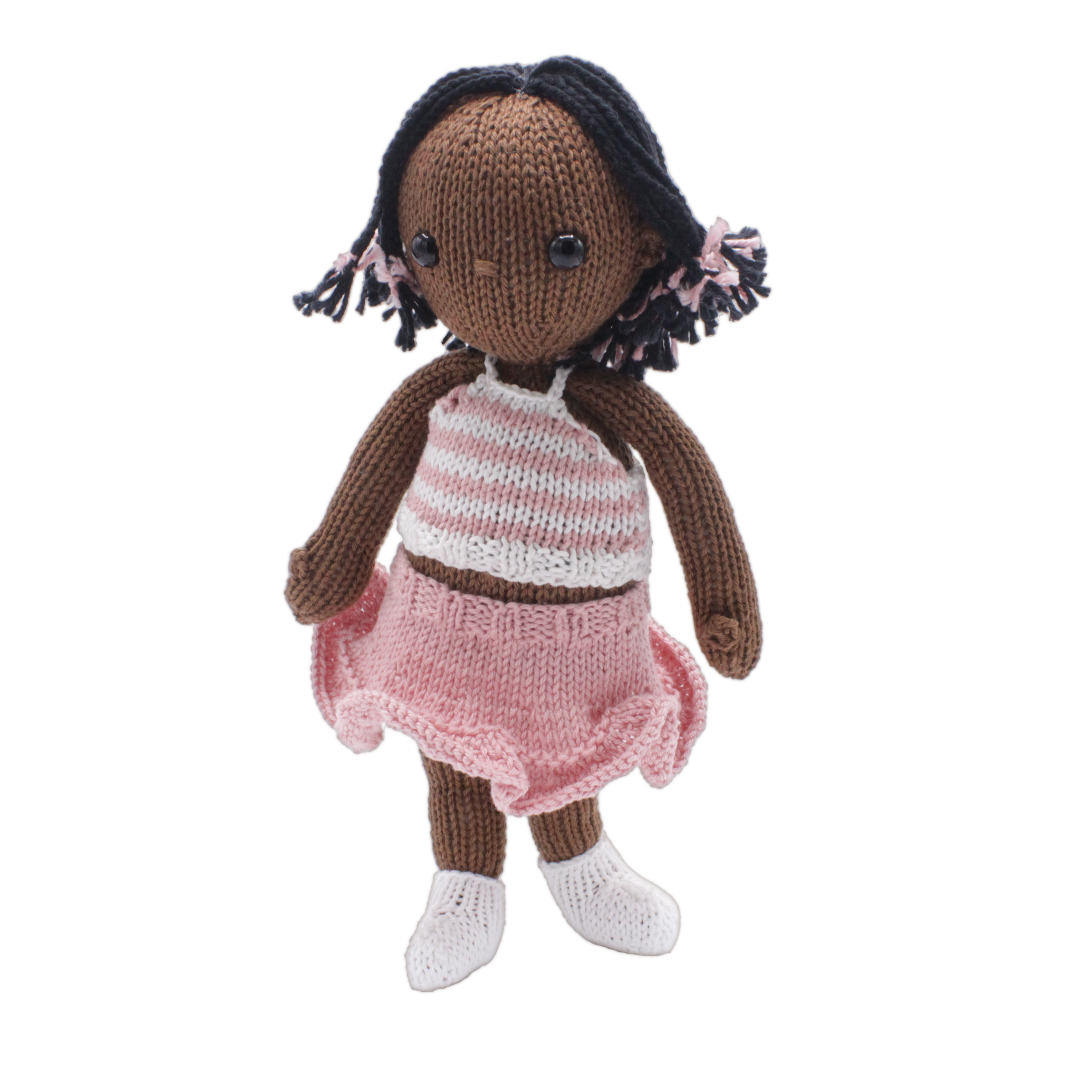 Knitted doll with brown hair, wearing a pink and white striped top and pink skirt on a white background.