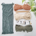 Macrame kit with ropes and tools on a white background
