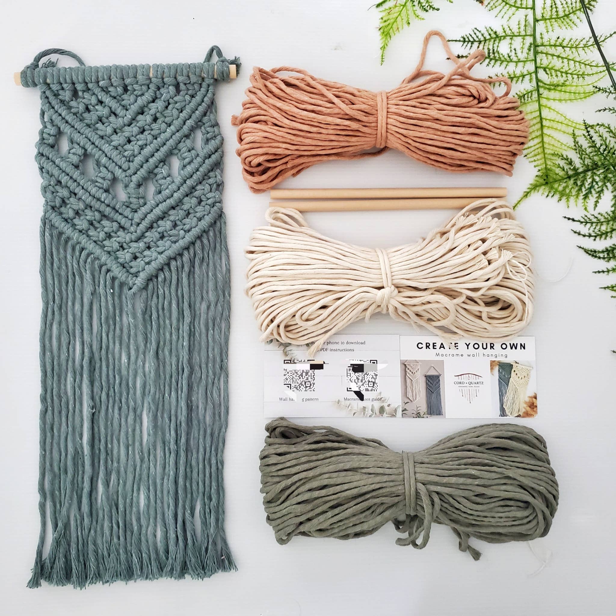 Macrame kit with ropes and tools on a white background