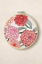 Embroidery hoop with floral design on a beige background