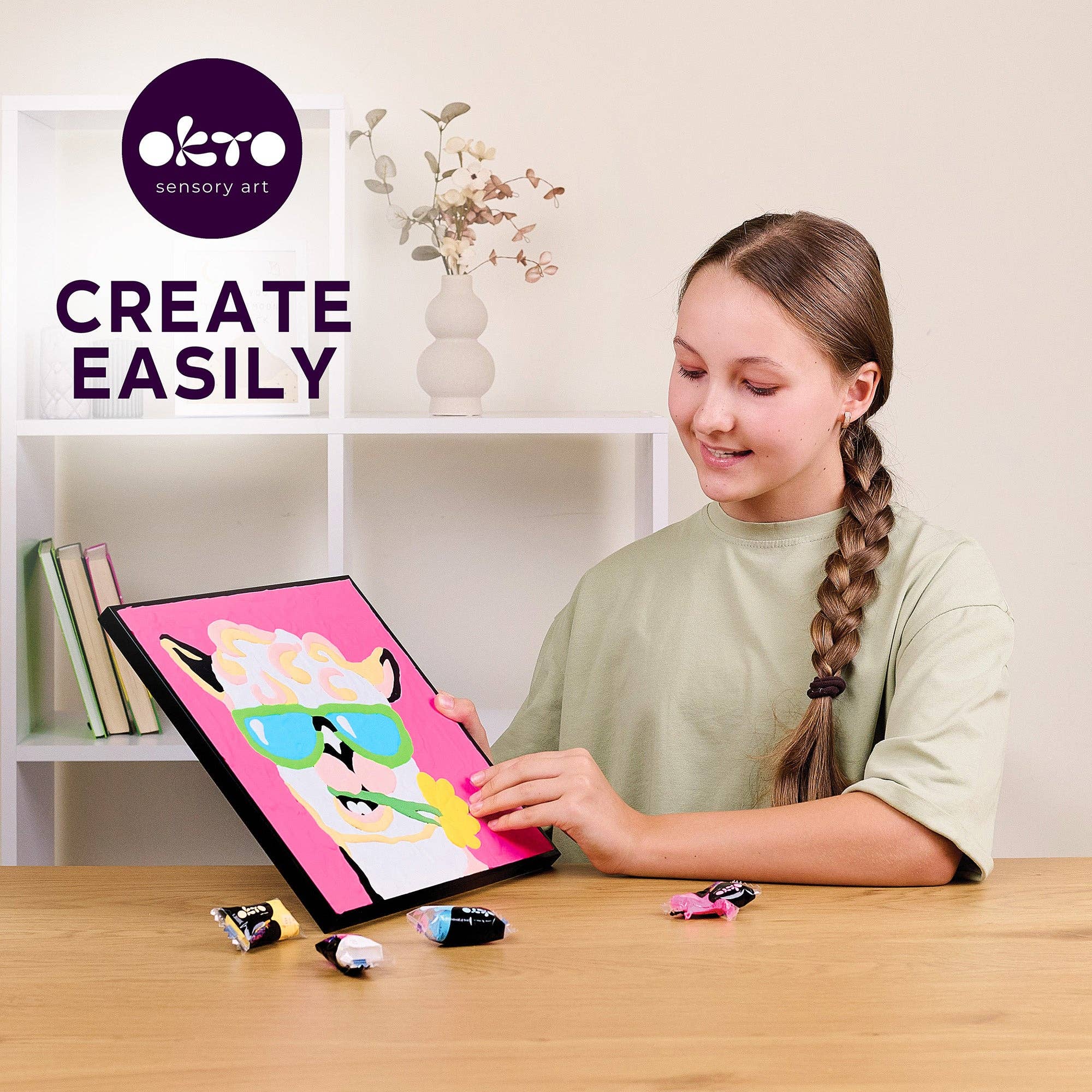 Girl creating art on a digital tablet with Okto Sensory Art branding.