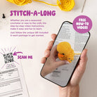 Hand holding a phone with a crochet duck toy displayed, QR code, and text about a 'Stitch-A-Long' on a white background.